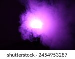 Purple light engulfed in smoke in the darkness