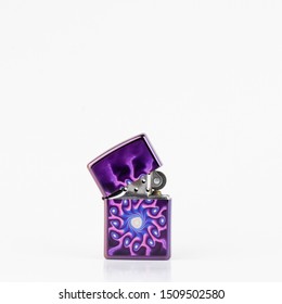 Purple lighter with psycodelic texture. Ligter with a cap. Stylish lighter isolated on white.