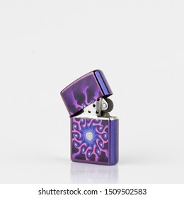 Purple lighter with psycodelic texture. Ligter with a cap. Stylish lighter isolated on white.