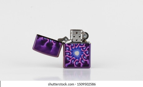 Purple lighter with psycodelic texture. Ligter with a cap. Stylish lighter isolated on white.