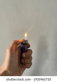 A Purple Lighter That Is Lit