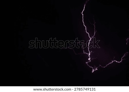 a purple lightning bolt descends vertically through a black night sky splitting into spreading branches and smaller electric tendrils