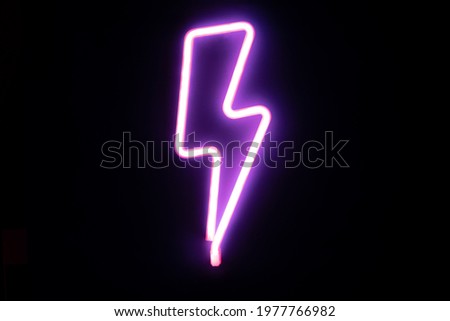 Purple lightning bolt mounted neon signs. High-voltage neon symbol, light banner design element colorful modern design trends. Cyberpunk concept