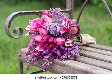 Purple Lilac And Tulips Flower Bouquet On A Wooden Old Bench