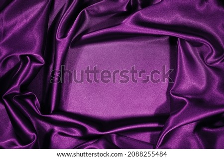  Purple magenta silk satin velvet. Beautiful soft wavy folds. Table top view. Flat lay. Shiny fabric background with copy space for design, montage. Christmas, Valentine.                              