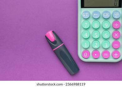 Purple marker and calculator on a purple background. The concept of financial accounting. Flat lay. - Shutterstock ID 2366988119