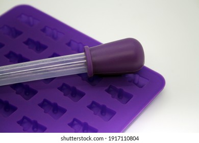 Purple Mold For Making Marmalade With A Pipette. Space For Text.