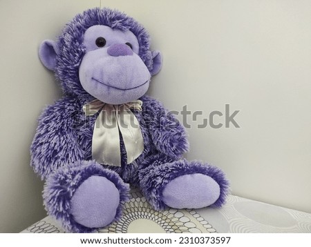 Purple monkey doll isolated on white background