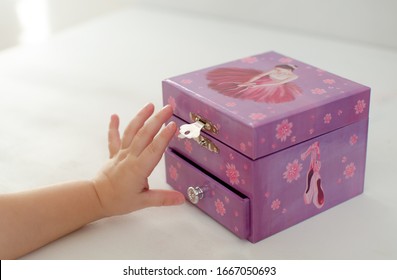 Purple Music Baby Jewelry Box With Ballerina. Children's Hand Reaches For The Box