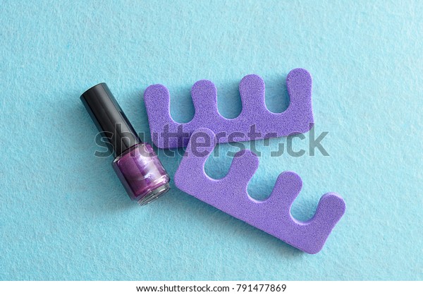 Purple nail polish\
with purple toe dividers\
