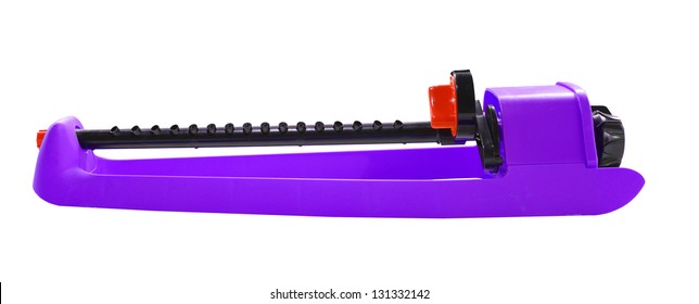 A Purple Oscillating Lawn And Garden Sprinkler Isolated On White