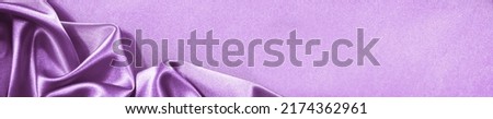 Purple pink silk satin background. Soft folds. Shiny fabric. Luxury lilac background. Space. Design. Web banner. Wide. Website header. Flat lay. Table top view. Birthday, wedding, Christmas, Valentine