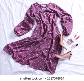 Purple Polka Dot Midi Dress, Beige Shoes, On Bed On White Sheet. Women's Stylish Spring Outfit. Trendy Clothes Collage. Flat Lay, Top View.