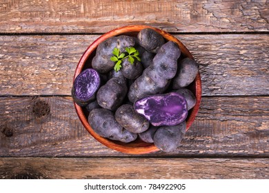 Purple Potato In A Rustic Cup On A Wooden Background.Top View