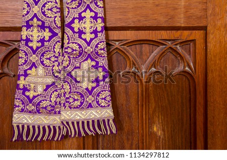 Purple priest stole used for confessions, vestment purple and gold as worn during confession and mass.