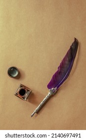Purple quill pen with a vintage inkwell, shot from the top on old paper with a place for text