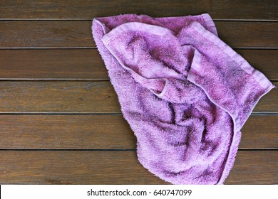 purple rag isolate on wooden background