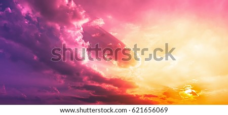 Purple red clouds with orange sun light in pink sky
