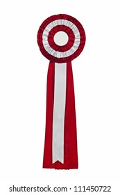 Purple Ribbon Award. Rosette Of Purple And Silver Satin Fabric With A Ribbon Tail Isolated On White