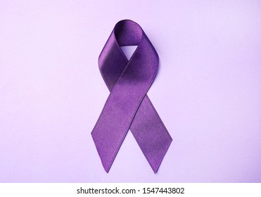 Purple Ribbon On Lilac Background, Top View. Domestic Violence Awareness