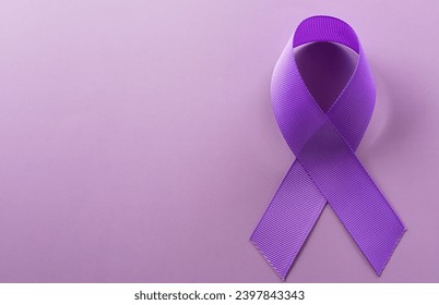 Purple ribbon on pastel paper background for supporting World Cancer Day campaign on February 4.