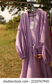 A Purple Robe Hangs On A Hanger.