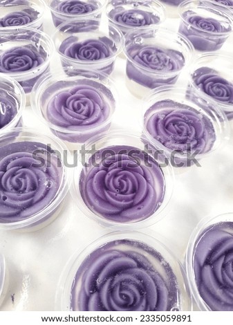 the purple rose drowning in the ocean jelly of the cup