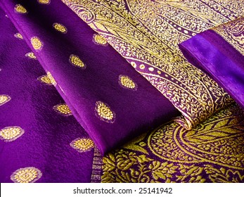 A Purple Saree Folded In Three With Beautiful Embroidery