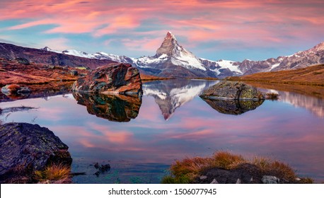 Purple sky above the lake. Panoramic morning view of Stellisee lake with Matterhorn peak on background. Colorful autumn sunrise on Swiss Alps, Zermatt resort location, Switzerland, Europe.  - Powered by Shutterstock