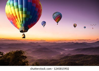 purple sky sunset hot air Colorful balloon flying with scenery beautiful romantic mountain hill and fog in Chiang Mai , Thailand. With couple traveller lover for honeymoon concept. - Shutterstock ID 1245815902