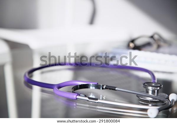 Purple Stethoscope On Glass Desk Healthcare Medical Objects