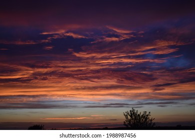 Purple Sunset Over A Field