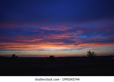 Purple Sunset Over A Field