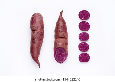 Purple Sweet Potato Cut Out Top Down View. Organic Raw Batat Roots Isolated On White Background Above Shot. Eco Vegetables For Healthy Antioxidant Diet. Violet Food Whole, Half And Sliced Pieces