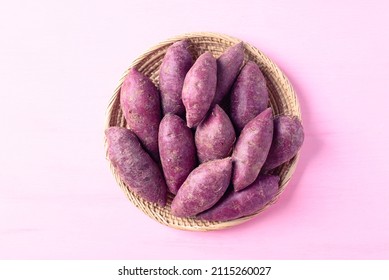 Purple Sweet Potatoes In Basket On Pink Background, Top View