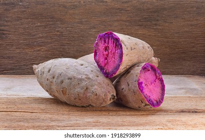 Purple Sweet Potatoes on a wooden table - Powered by Shutterstock