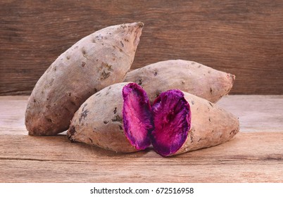 Purple Sweet Potatoes on a wooden table - Powered by Shutterstock