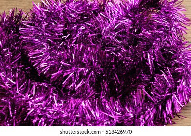 Purple Tinsel To Decorate A Christmas Tree