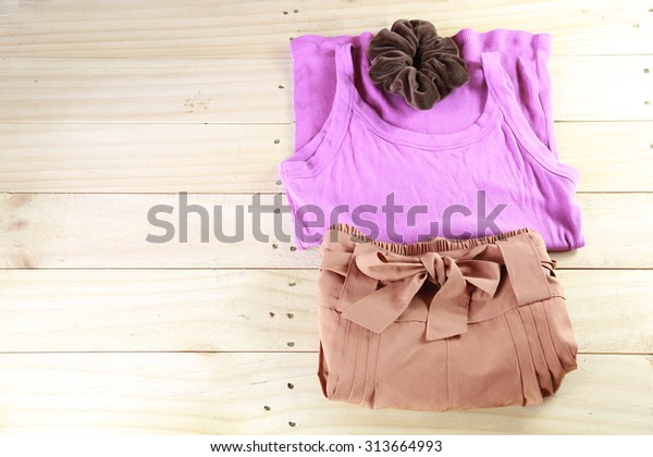 purple shirt and brown pants