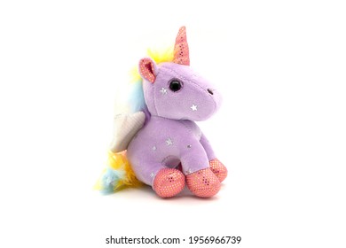 Purple unicorn plush toy. Isolated on white background 