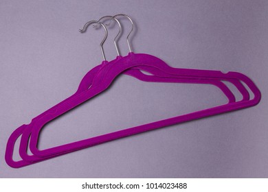 Purple Velvet Hangers On The Gray Background