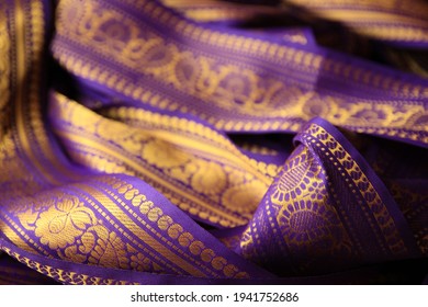 Purple Violet Indian Sari Border With Gold Paisley Pattern. Purple Background.