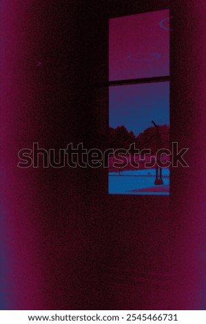 A purple wall with a window and a persons reflection