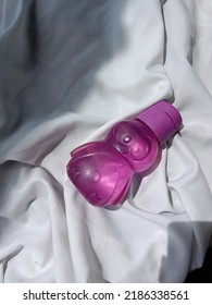 Purple Water Bottle On White Background And Sunlight