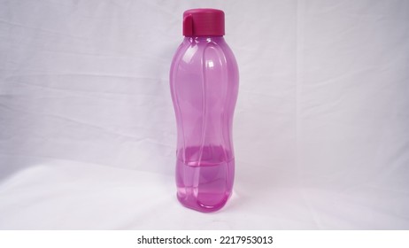 A Purple Water Bottle On A White Background