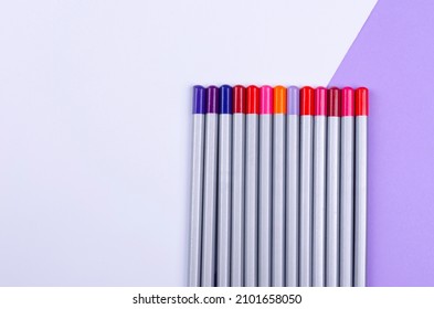 Purple and white background. Copy space. Pencils in a row.