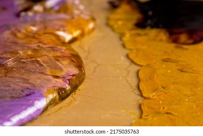 Purple Yellow Caramel Mass For Preparation Of Lollipops Spread On Pastry Table. Cooking Sweet Candy. Handmade Sweets. Background Of Sweet Food, Candies For Holiday, Childrens Birthday. Extra Close Up.