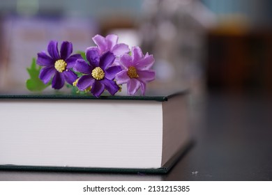 Purrle Flower On Hardcover Law Book In Blur Office Room For Business Or Education Background