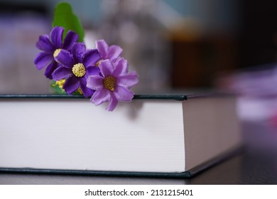 Purrle Flower On Hardcover Law Book In Blur Office Room For Business Or Education Background