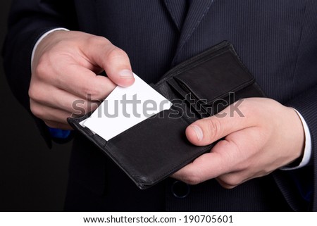 purse with blank visiting card in business man hand